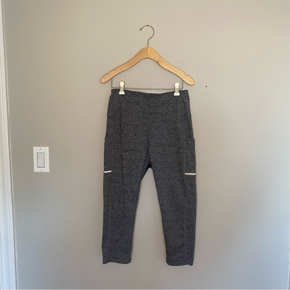 Black and grey Olacia high waisted cropped workout leggings.